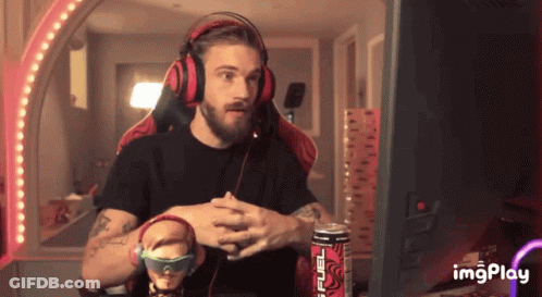 A Man Wearing Headphones Is Sitting In Front Of A Computer Screen With A Can Of Monster Energy Drink In Front Of Him GIF