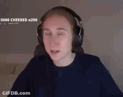 A Man Wearing Headphones Is Sitting In Front Of A Computer With His Eyes Closed . GIF