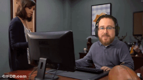A Man Wearing Headphones Is Sitting In Front Of A Dell Computer GIF