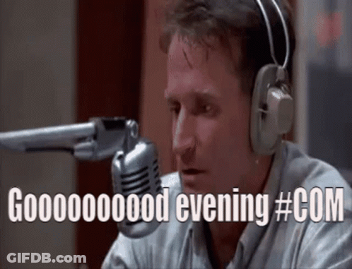 A Man Wearing Headphones Is Sitting In Front Of A Microphone And Saying Good Evening #Com GIF
