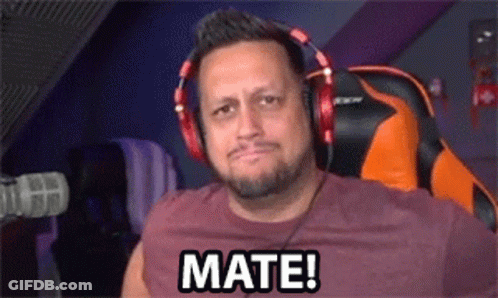 A Man Wearing Headphones Is Sitting In Front Of A Microphone And Saying Mate ! GIF