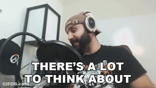 A Man Wearing Headphones Is Sitting In Front Of A Microphone And Saying `` There 'S A Lot To Think About '' GIF