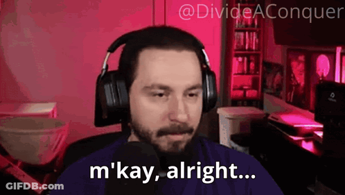 A Man Wearing Headphones Is Sitting In Front Of A Microphone And Says M ' Kay Alright . GIF