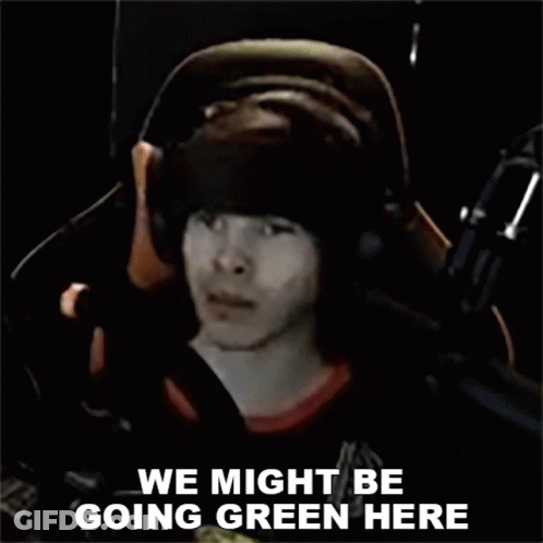 A Man Wearing Headphones Is Sitting In Front Of A Microphone And Says We Might Be Going Green Here . GIF