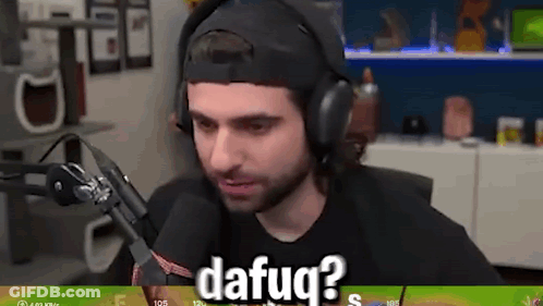 A Man Wearing Headphones Is Sitting In Front Of A Microphone And Talking Into It . GIF