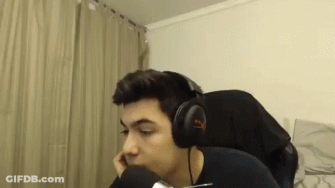 A Man Wearing Headphones Is Sitting In Front Of A Microphone In A Room . GIF