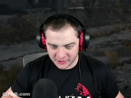 A Man Wearing Headphones Is Sitting In Front Of A Microphone . GIF