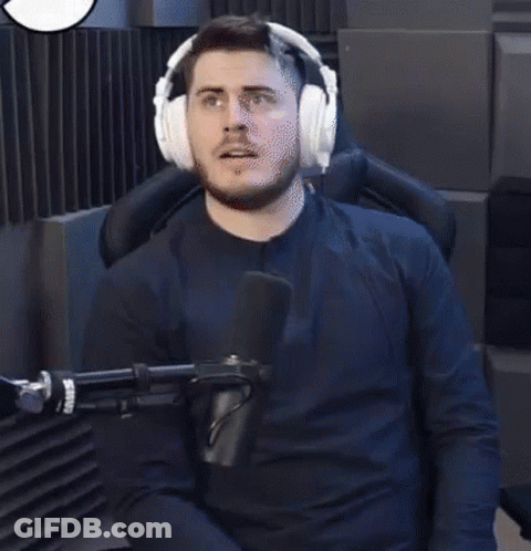 A Man Wearing Headphones Is Sitting In Front Of A Microphone With The Word Wasted In Red Letters Behind Him . GIF