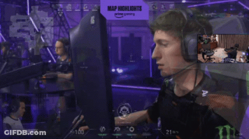 A Man Wearing Headphones Is Sitting In Front Of A Monitor With A Sign That Says Map Highlights On It GIF