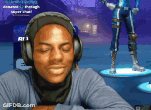 A Man Wearing Headphones Is Sitting In Front Of A Screen That Says ' @Chrellofriending ' On It GIF