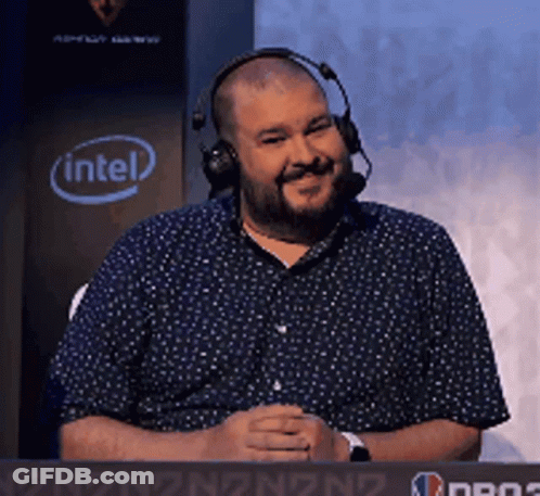 A Man Wearing Headphones Is Sitting In Front Of A Sign That Says Intel GIF