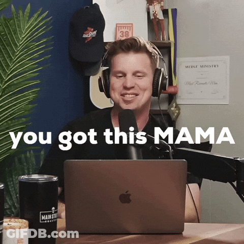 A Man Wearing Headphones Is Sitting In Front Of An Apple Laptop With The Words " You Got This Mama " Behind Him GIF