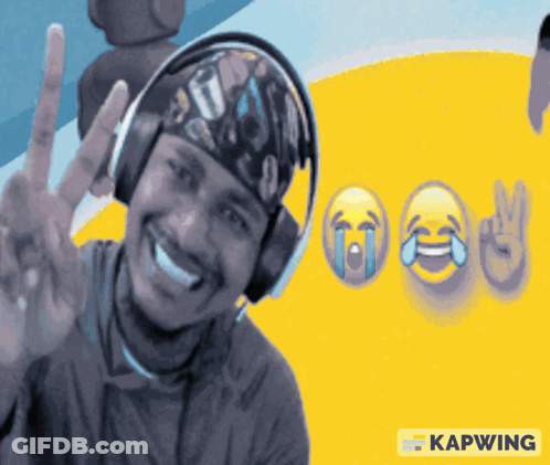 A Man Wearing Headphones Is Smiling And Giving A Peace Sign In Front Of A Yellow Background With Kapwing Written On It GIF