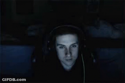 A Man Wearing Headphones Is Smiling And Looking At The Camera GIF