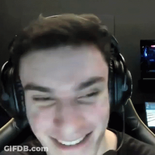 A Man Wearing Headphones Is Smiling And Making A Face GIF