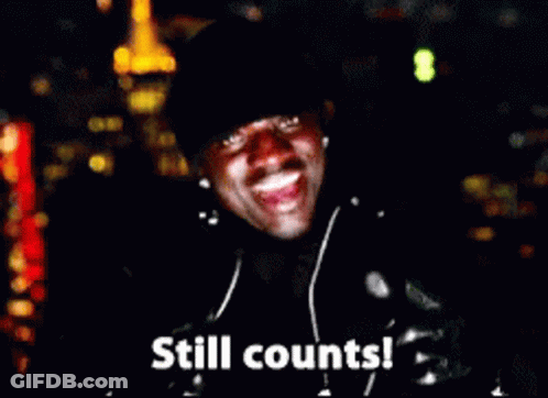 A Man Wearing Headphones Is Smiling And Says Still Counts ! GIF