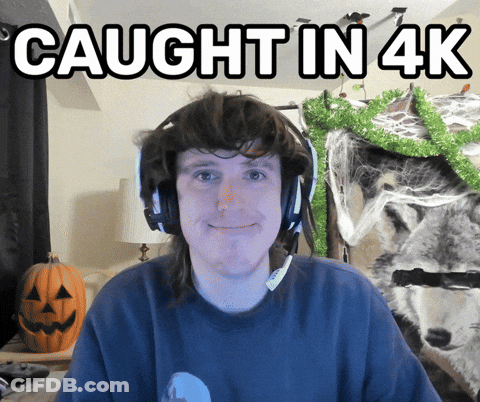 A Man Wearing Headphones Is Smiling With The Words Caught In 4K Above Him GIF