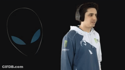 A Man Wearing Headphones Is Standing In Front Of A Monster Logo GIF