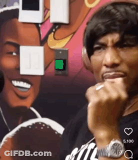A Man Wearing Headphones Is Standing In Front Of A Painting GIF