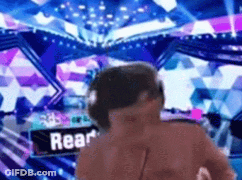 A Man Wearing Headphones Is Standing In Front Of A Sign That Says Rear On It . GIF
