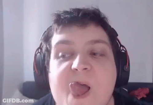 A Man Wearing Headphones Is Sticking His Tongue Out While Making A Funny Face . GIF