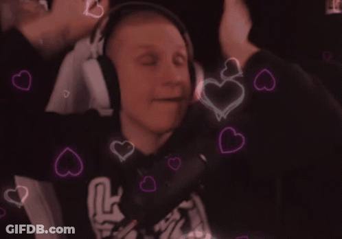 A Man Wearing Headphones Is Surrounded By Hearts That Are Pink And Blue GIF