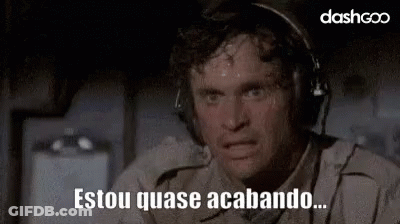 A Man Wearing Headphones Is Sweating And Making A Funny Face While Sitting On A Plane . GIF