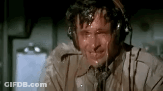 A Man Wearing Headphones Is Sweating While Sitting In A Plane . GIF