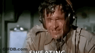 A Man Wearing Headphones Is Sweating While Sitting In An Airplane Cockpit . GIF