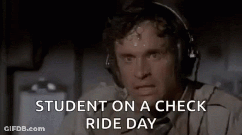 A Man Wearing Headphones Is Sweating While Sitting On A Plane And Says `` Student On A Check Ride Day '' . GIF