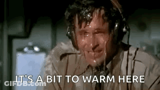 A Man Wearing Headphones Is Sweating While Talking On A Phone . GIF