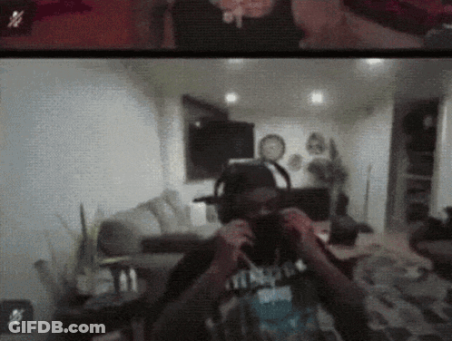 A Man Wearing Headphones Is Taking A Picture Of Himself In A Room GIF