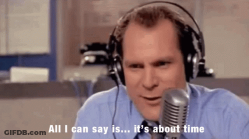 A Man Wearing Headphones Is Talking Into A Microphone And Says " All I Can Say Is It 'S About Time " GIF