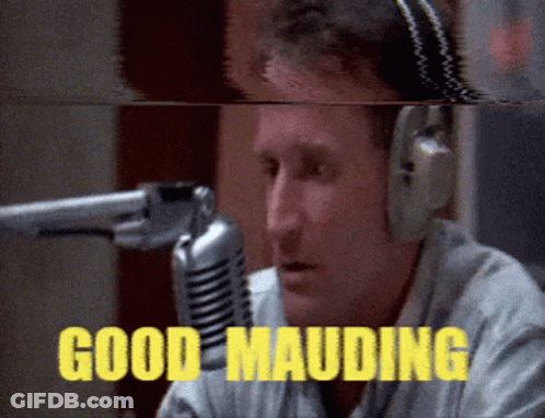 A Man Wearing Headphones Is Talking Into A Microphone And The Words Good Mauding Are Visible GIF