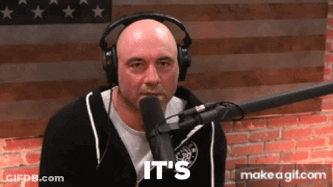 A Man Wearing Headphones Is Talking Into A Microphone And The Words It 'S Are On The Screen Behind Him GIF