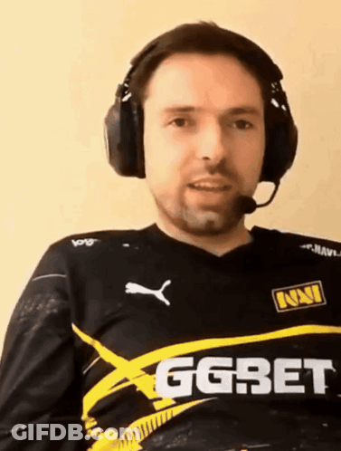 A Man Wearing Headphones Is Wearing A Shirt That Says Ggbet GIF