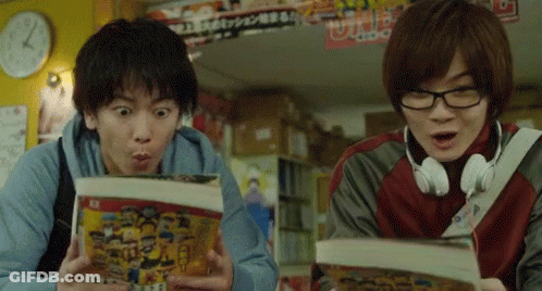 A Man Wearing Headphones Looks Surprised While Another Man Looks At A Book GIF