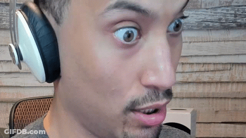 A Man Wearing Headphones Looks Surprised With His Mouth Open GIF