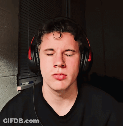 A Man Wearing Headphones Makes A Funny Face GIF