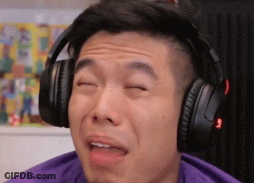 A Man Wearing Headphones Making A Funny Face With His Eyes Closed GIF