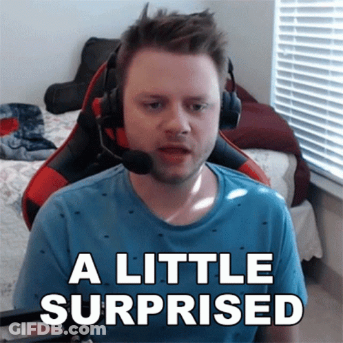 A Man Wearing Headphones Says A Little Surprised In Front Of A Window GIF