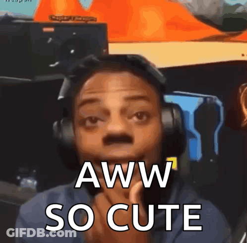A Man Wearing Headphones Says Aww So Cute . GIF