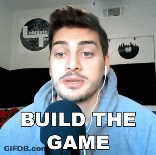 A Man Wearing Headphones Says " Build The Game " In Front Of A Microphone GIF