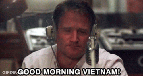 A Man Wearing Headphones Says " Good Morning Vietnam " GIF