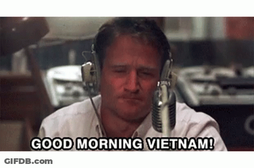 A Man Wearing Headphones Says " Good Morning Vietnam " GIF