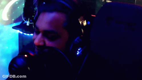 A Man Wearing Headphones Says " Here Comes The Party Pooper " GIF