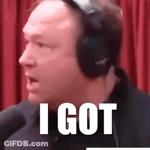 A Man Wearing Headphones Says I Got In Front Of A Red Curtain . GIF