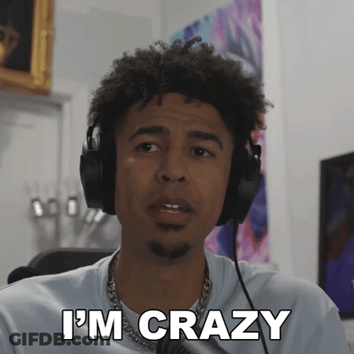 A Man Wearing Headphones Says " I 'M Crazy " In Front Of A Microphone GIF
