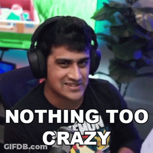 A Man Wearing Headphones Says " Nothing Too Crazy " In Front Of A Green Screen GIF