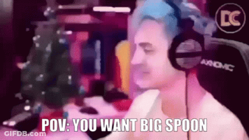 A Man Wearing Headphones Says " Pov You Want Big Spoon " In Front Of A Christmas Tree GIF